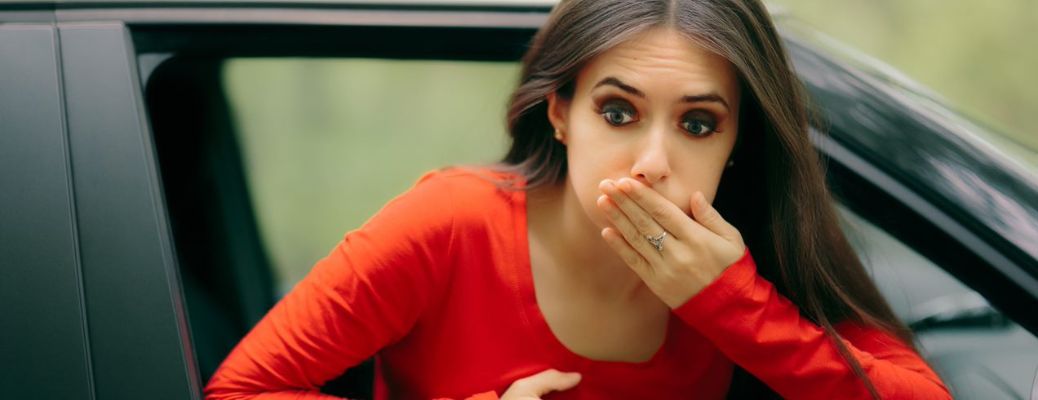 One lady in red top is feeling nausea in the car.