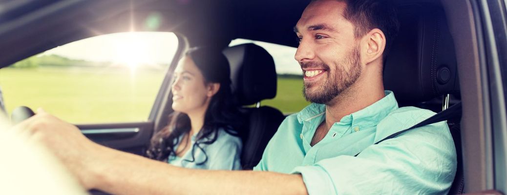 One couple is travelling in a car.