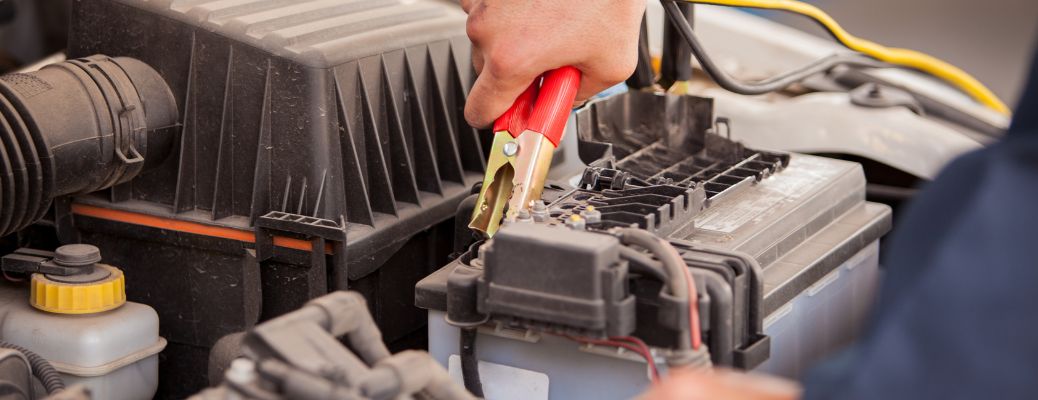 a hand checking the battery of a car