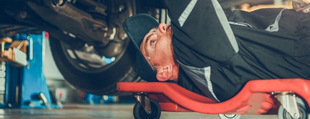 Mechanic working under a vehicle