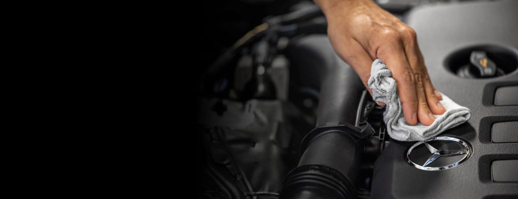 Mechanic cleaning a Mercedes-Benz vehicle