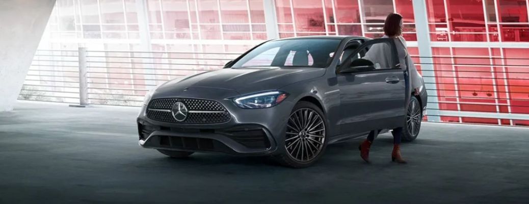 woman getting out of the 2025 Mercedes-Benz C 300 Sedan