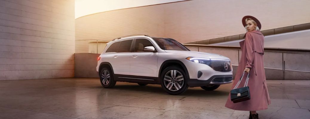 a woman posing near a 2025 Mercedes-Benz EQB