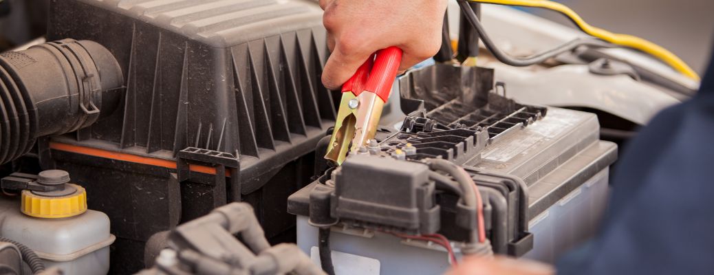 Mechanic jump starting a dead car battery