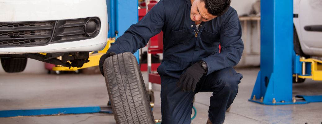 a technician looking at a tire