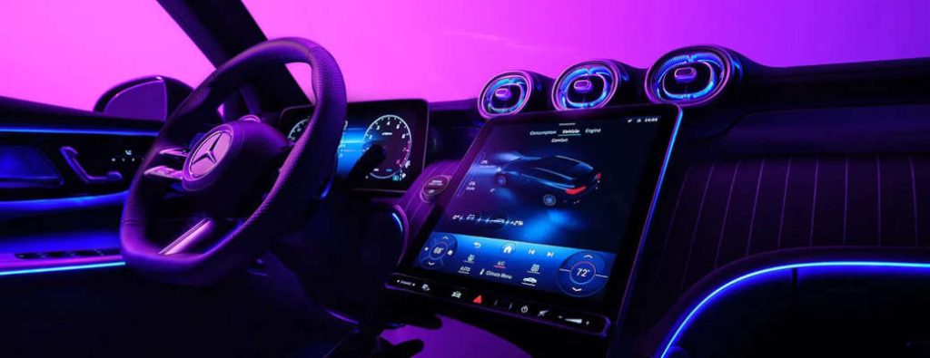 The large infotainment screens in the 2025 Mercedes-Benz GLC 300 SUV; interior illuminated with customizable LED lighting.