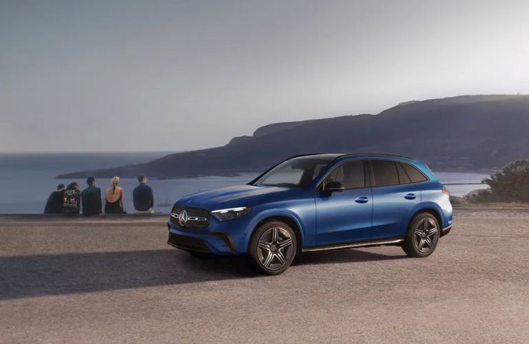 people enjoying sea view with a 2025 Mercedes-Benz parked 