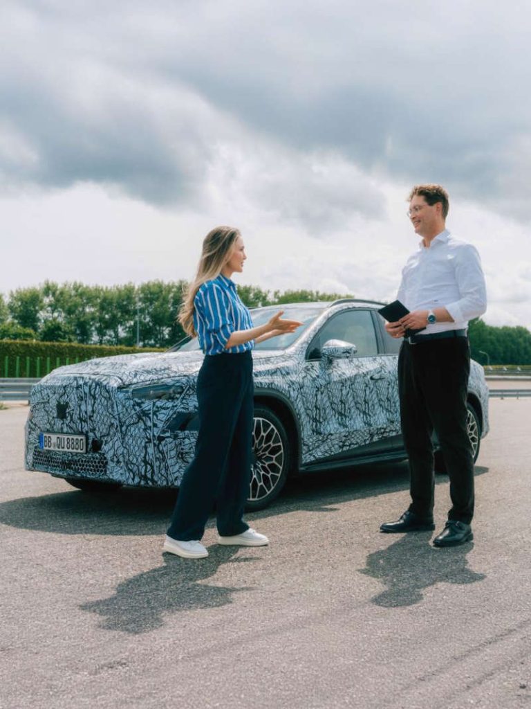 Two people discussing the Mercedes GLC EV