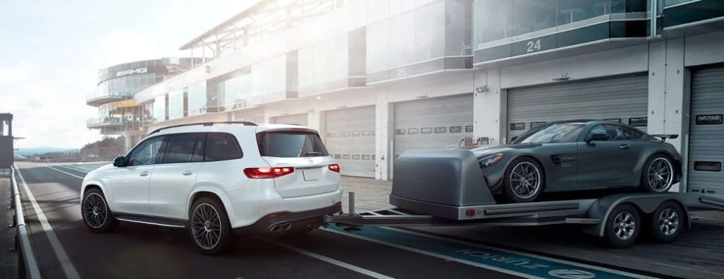 The 2025 Mercedes-Benz GLS-Class SUV pulling another Mercedes on a trailer.