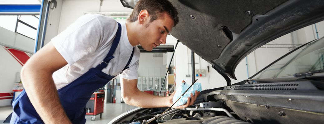 A mechanic checking for engine oil