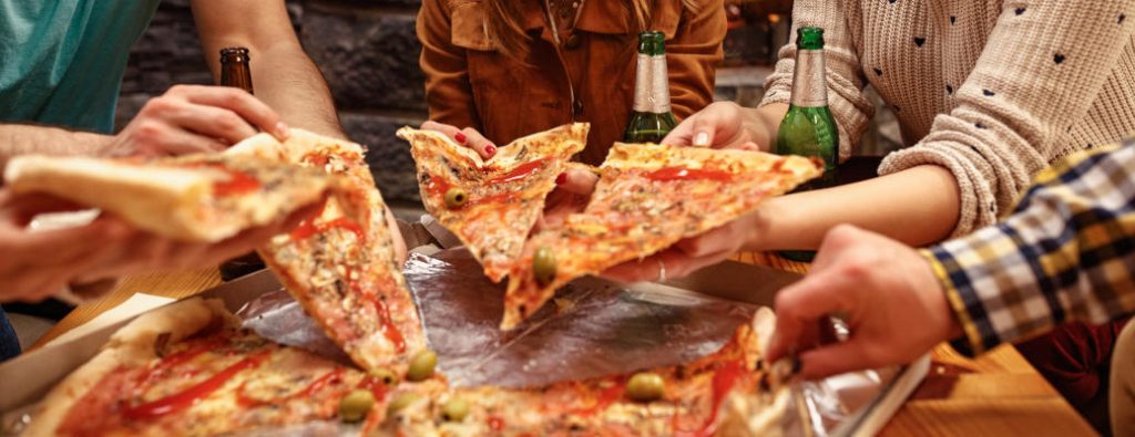 People sharing pizza at one of the best pizza places in Scottsdale