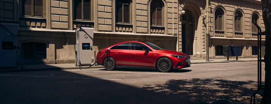 side view of a Mercedes-Benz getting charged at a public charging station