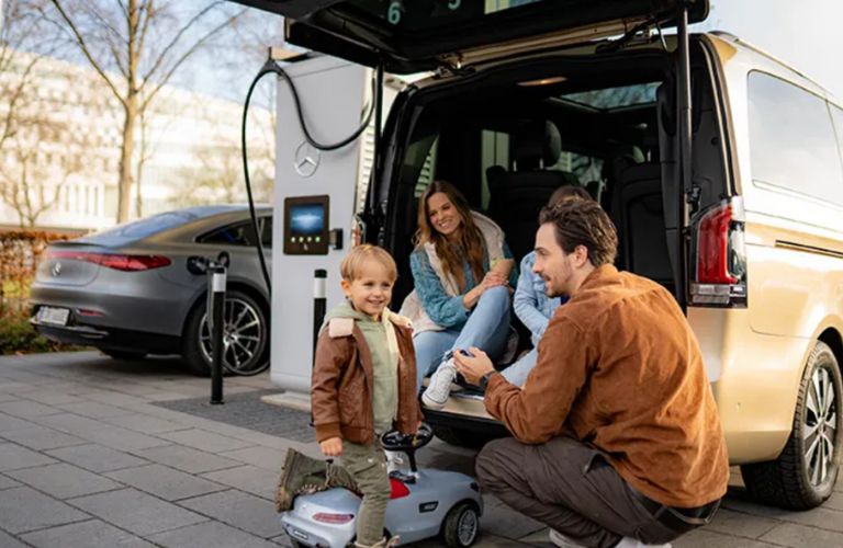a family charging a Mercedes-Benz on the go