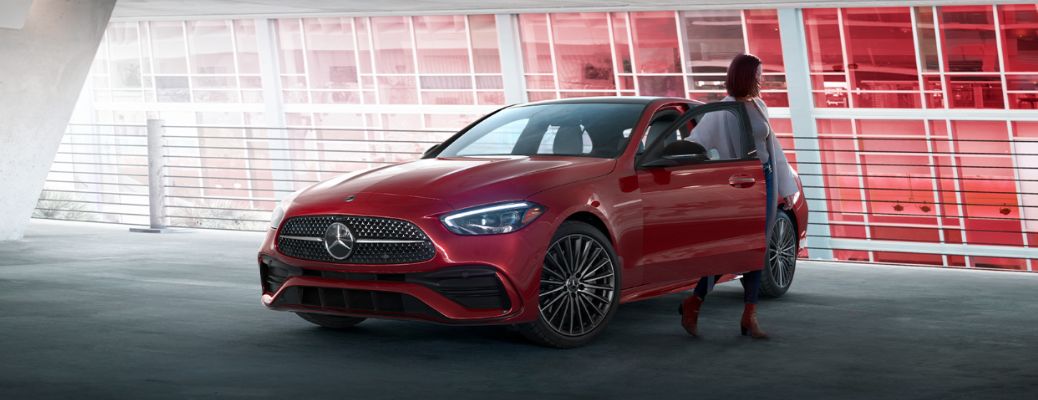 a woman getting out of a 2026 Mercedes-Benz C-Class Sedan