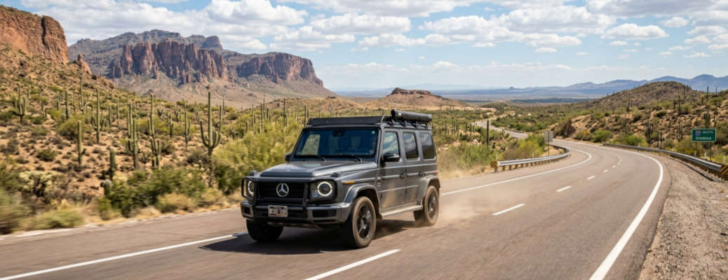 A Mercedes SUV driving on a hot desert highway in the Arizona desert