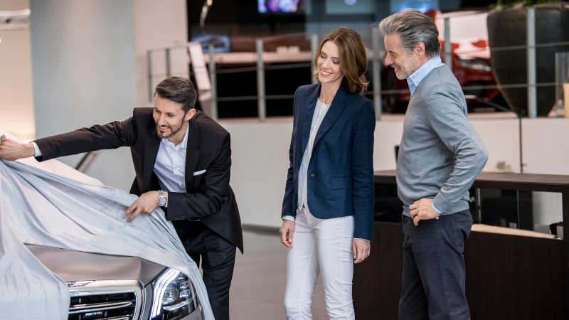 A couple receiving their custom Mercedes-Benz at the Mercedes Center of Excellence