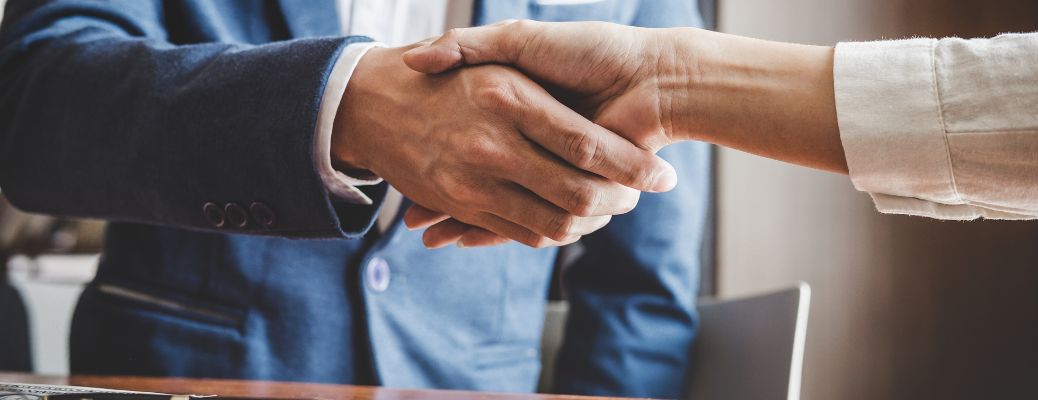 Salesperson shaking hands with customer after the deal