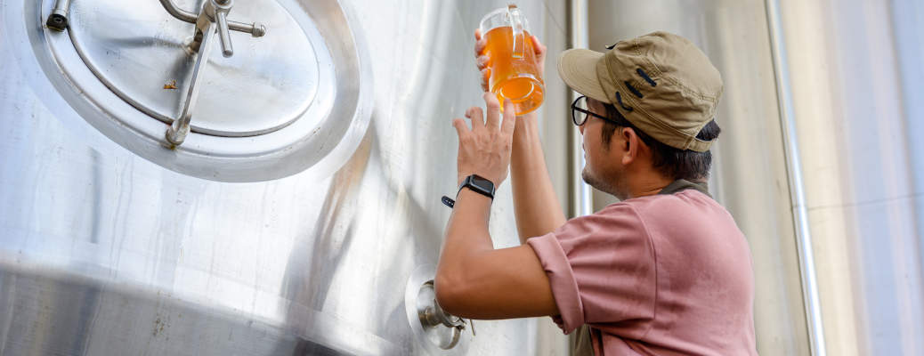 A microbrewery brewmaster testing the color and clarity of a beer near Scottsdale and Phoenix