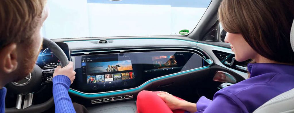 A couple in a Mercedes-Benz equipped with the MBUX Hyperscreen, which runs on the MB.OS