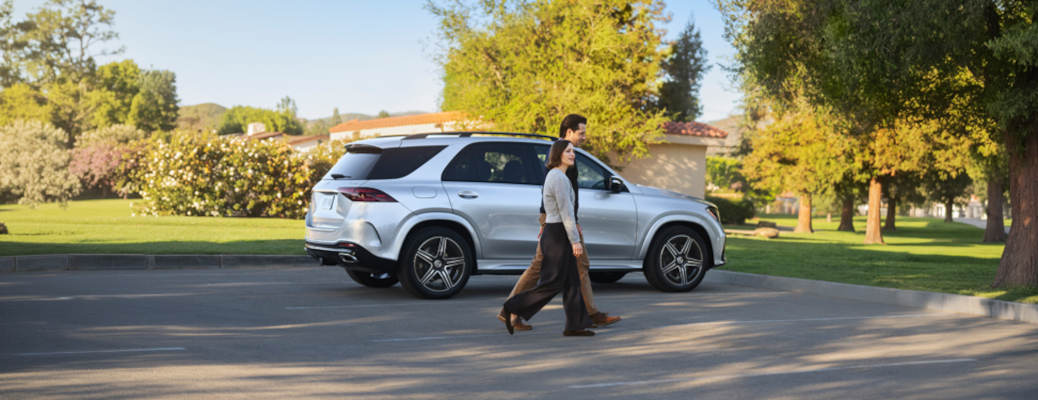 A couple that leased a Mercedes-Benz in Scottsdale walking near their vehicle