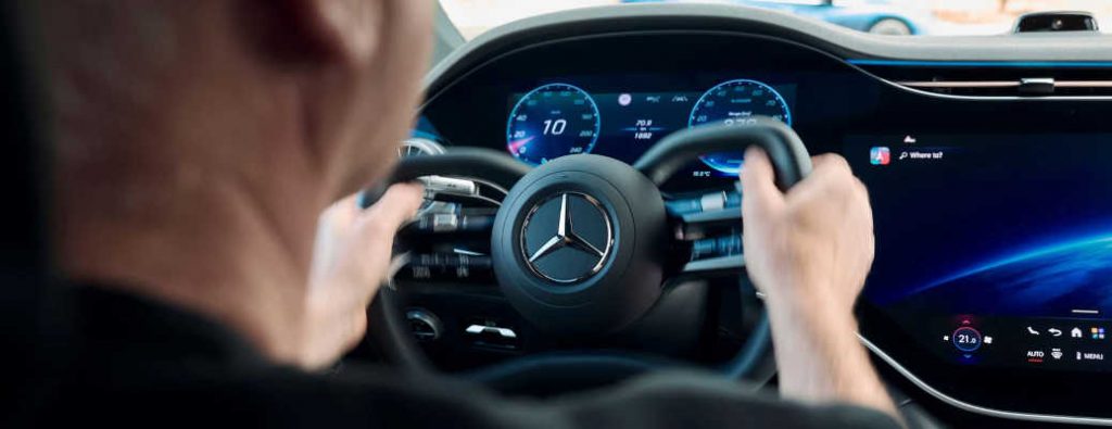 A man test-driving a vehicle equipped with Mercedes-Benz drive-by-wire technology.