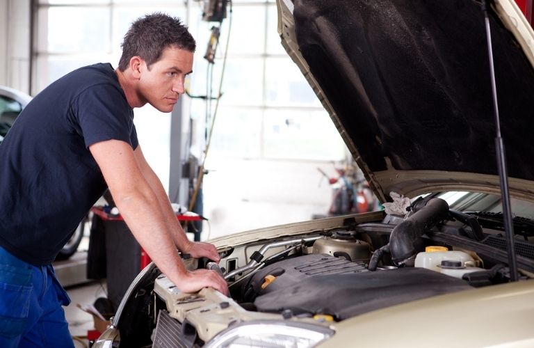 Service technician inspecting a vehicle