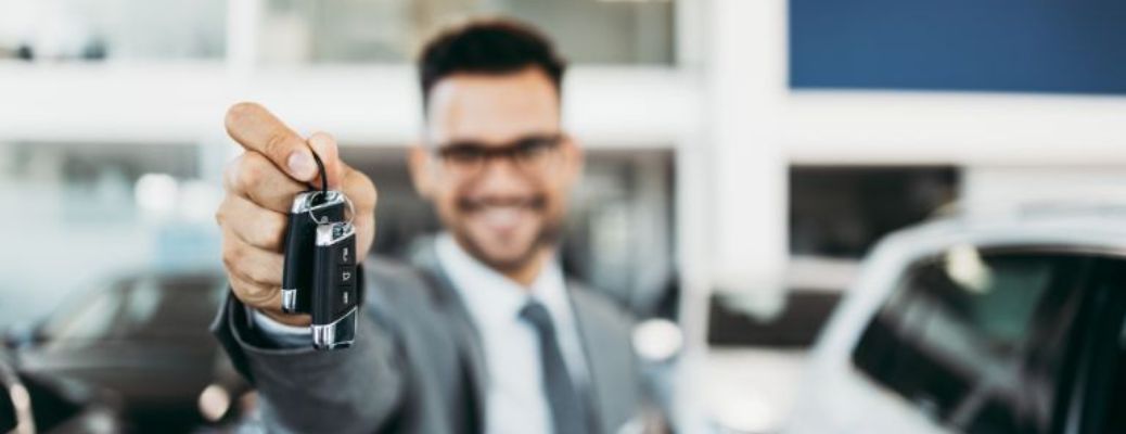 Person holding up a car key