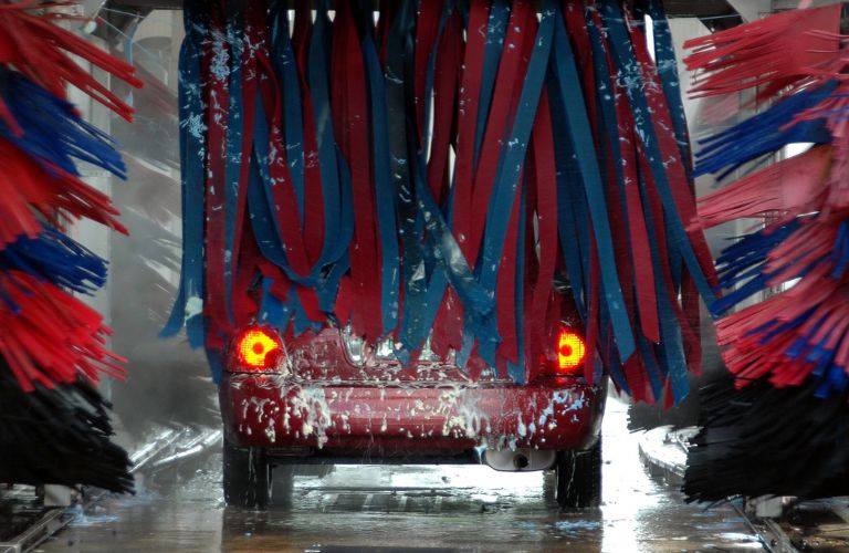 A car going through a car wash equipment