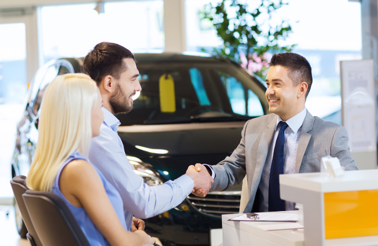 A couple talking to a salesman 