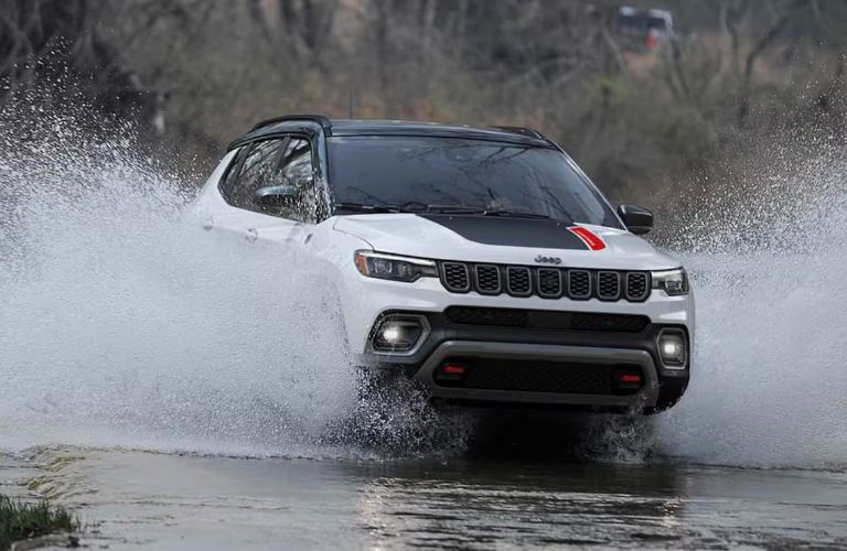 2026 Jeep Compass crossing a stream