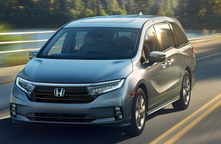 One grey color 2022 Honda Odyssey is running on the road.