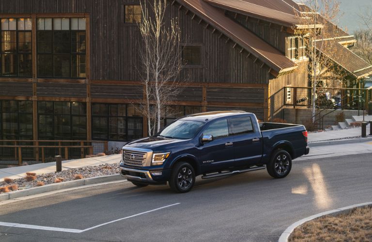 2023 Nissan TITAN Blue driving on the road