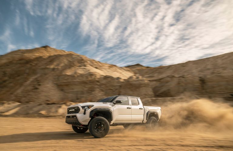 side view of the 2025 Toyota Tacoma navigating sandy terrain