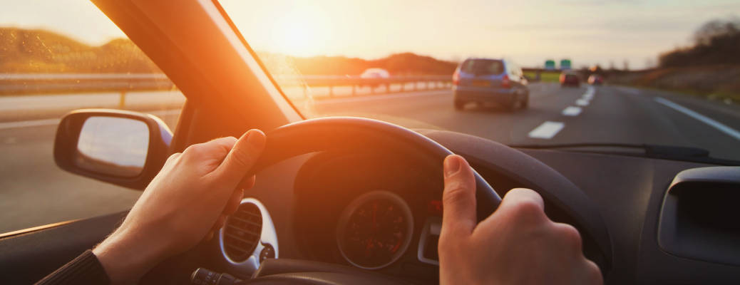 A person driving in the California sun
