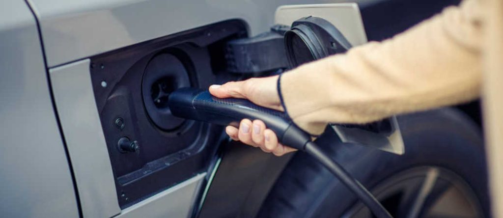 A man charging his Toyota EV at a Toyota home charging station