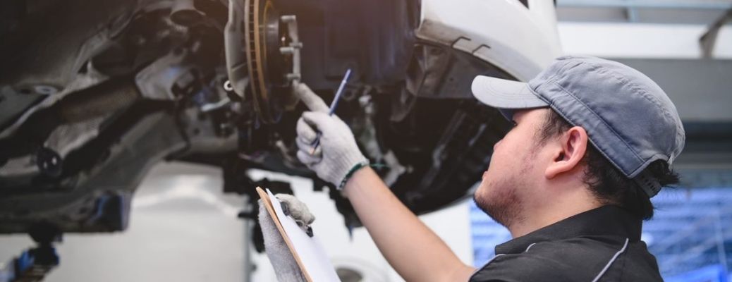 Mechanic inspecting the brakes in a vehicle