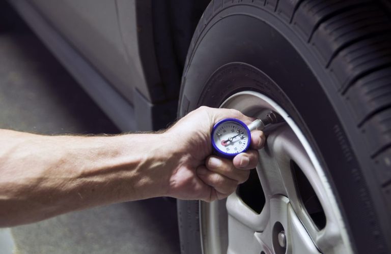 Mechanic checking tire pressure