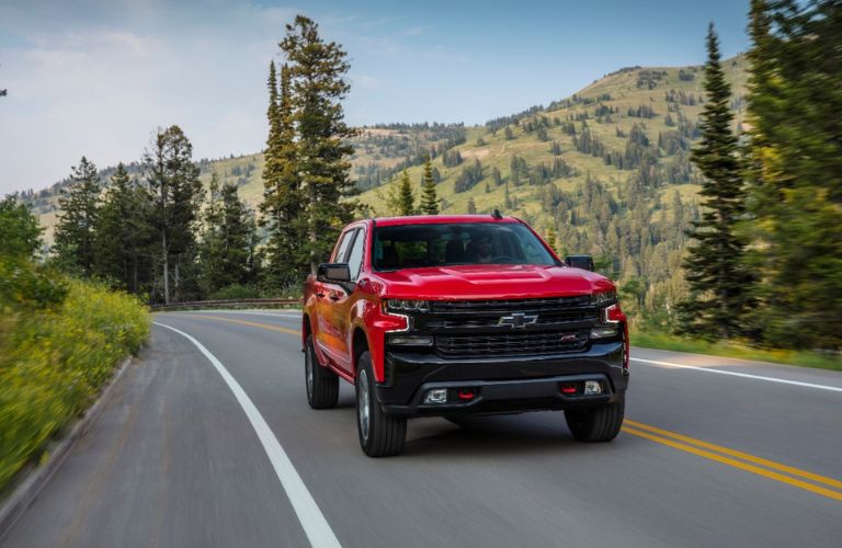 2020 Chevy Silverado Trail Boss driving on a road in the woods