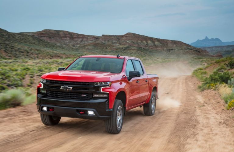 2020 Chevy Silverado Trail Boss driving through a muddy field 