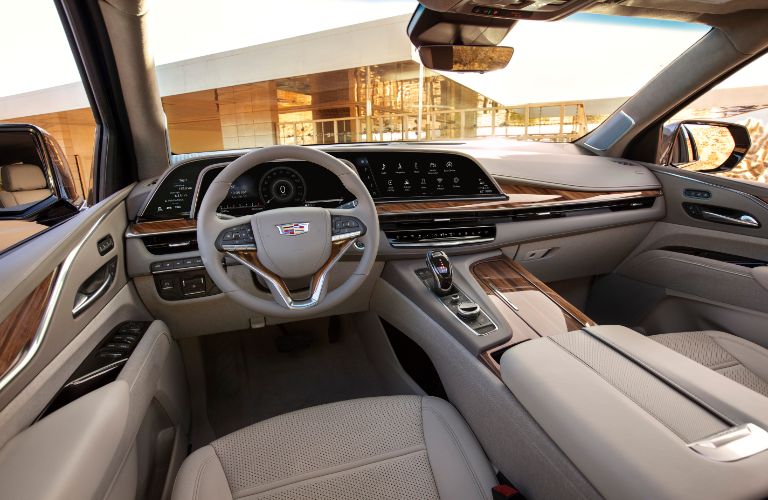 2021 Cadillac Escalade interior shot of front seating, steering wheel, and dashboard design