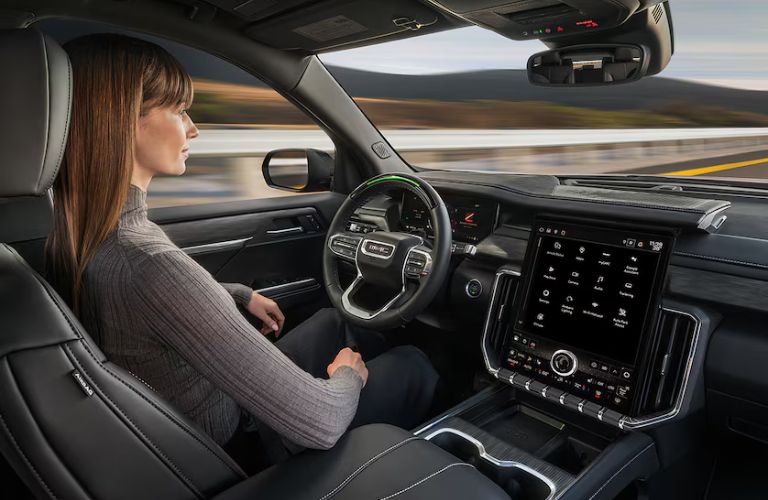 2026 GMC Acadia with a driver inside