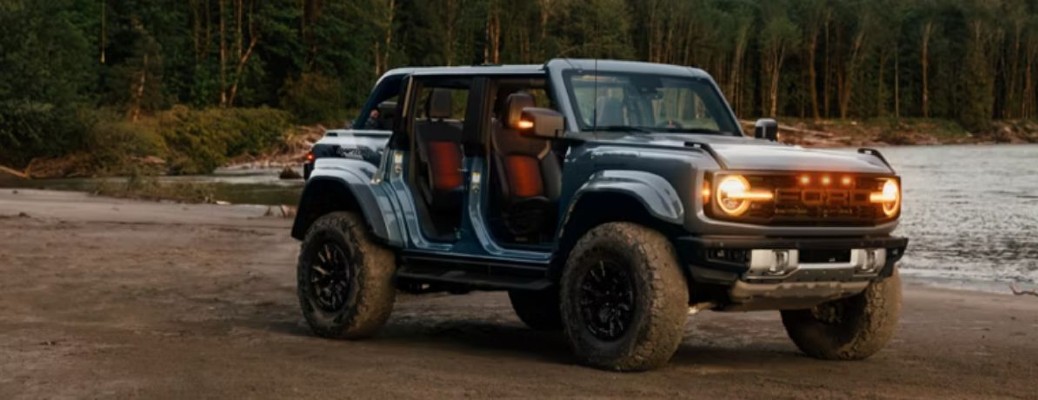 2026 Ford Bronco parked on a beach with lights on