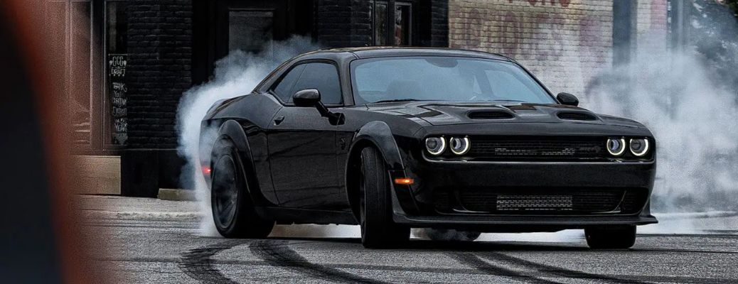 A 2022 Dodge Challenger drifting on a road