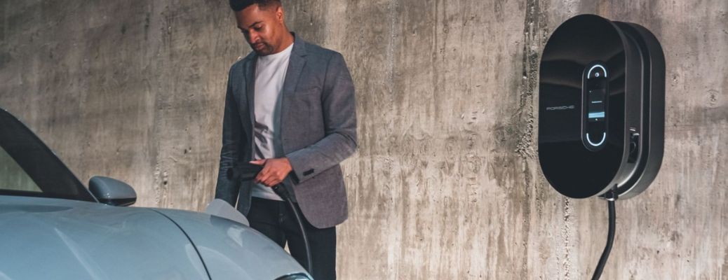 a man charging a Porsche