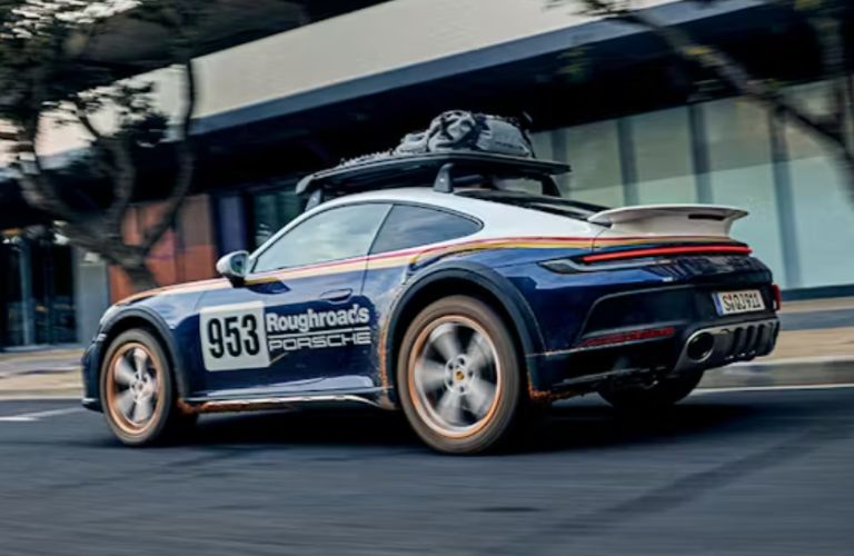rear and side view of a Porsche with a roof basket