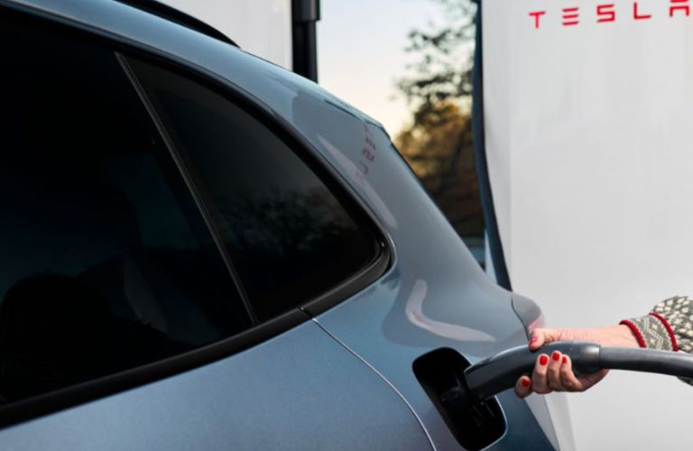 close up of a Porsche EV being charged