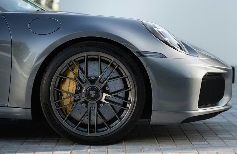 Close-up of Porsche ceramic brakes showing yellow calipers on Porsche 911 Turbo S