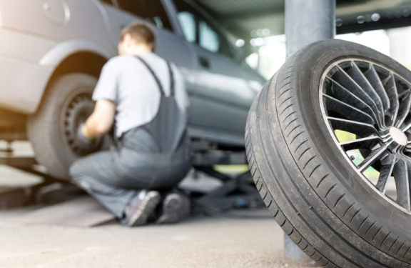 Technician replacing a vehicle's tire