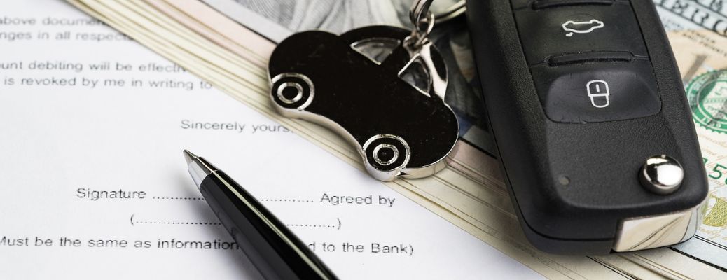 image of a caar key and pen on a document