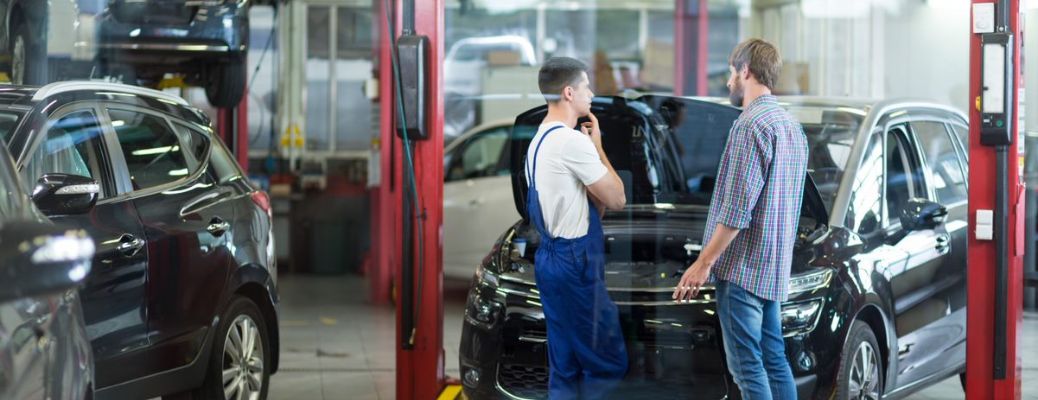 a man and technician talking at a service center